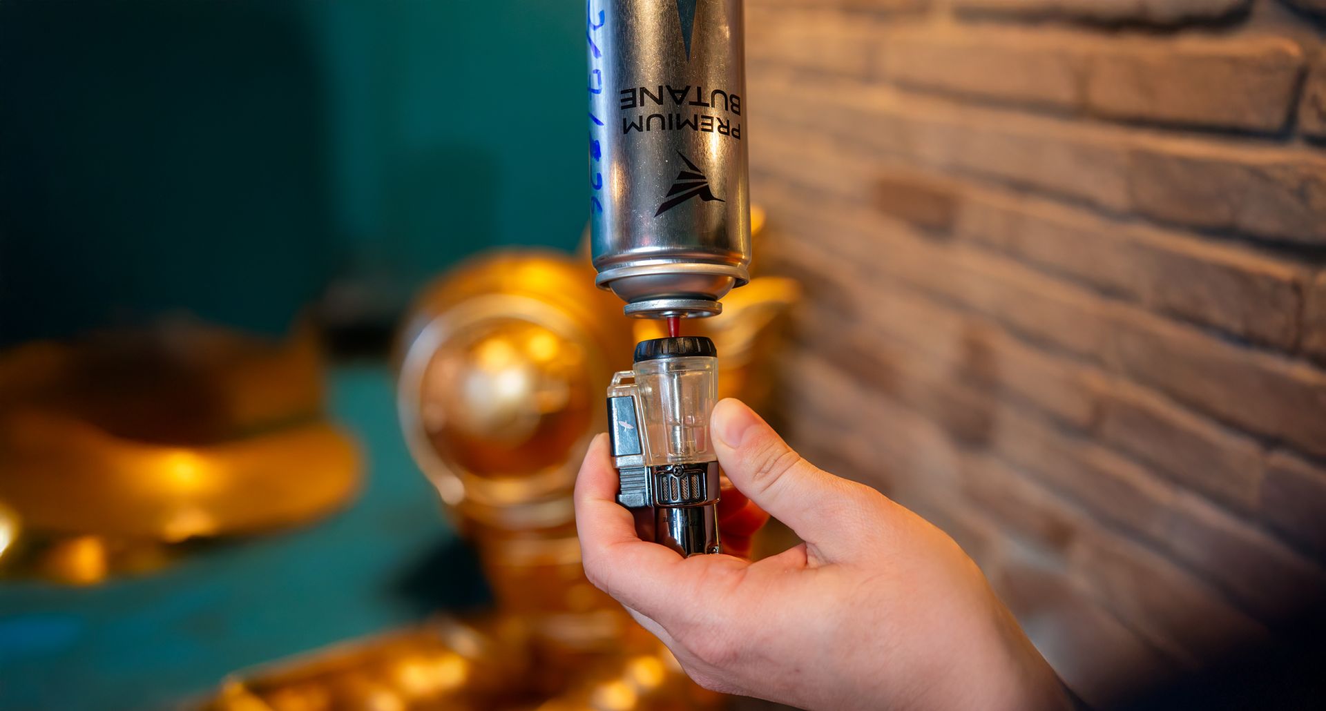 Press the butane can straight down into the refill valve—no angle—to prevent leaking